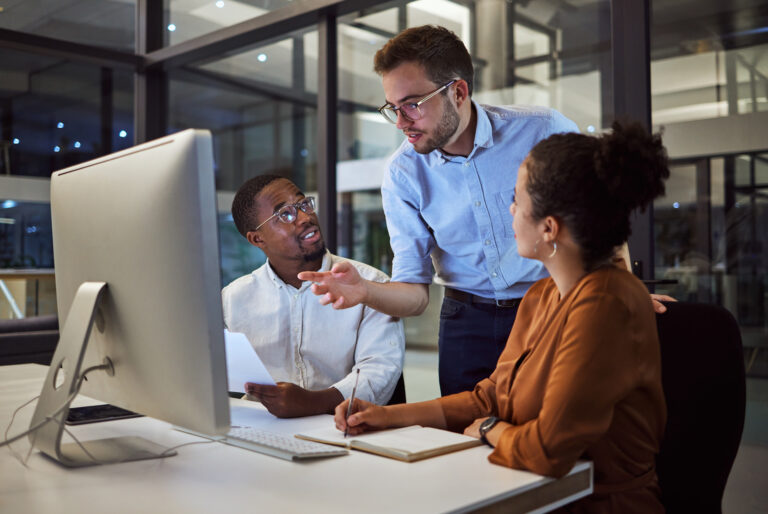 Diverse business people looking at computer